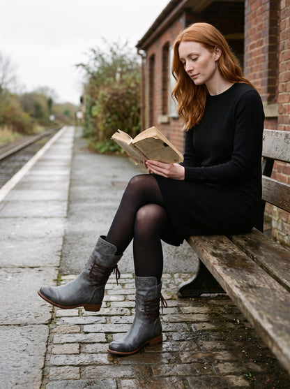 Women's Vintage Combat Boots – Grey – worn with a knit dress on a station platform